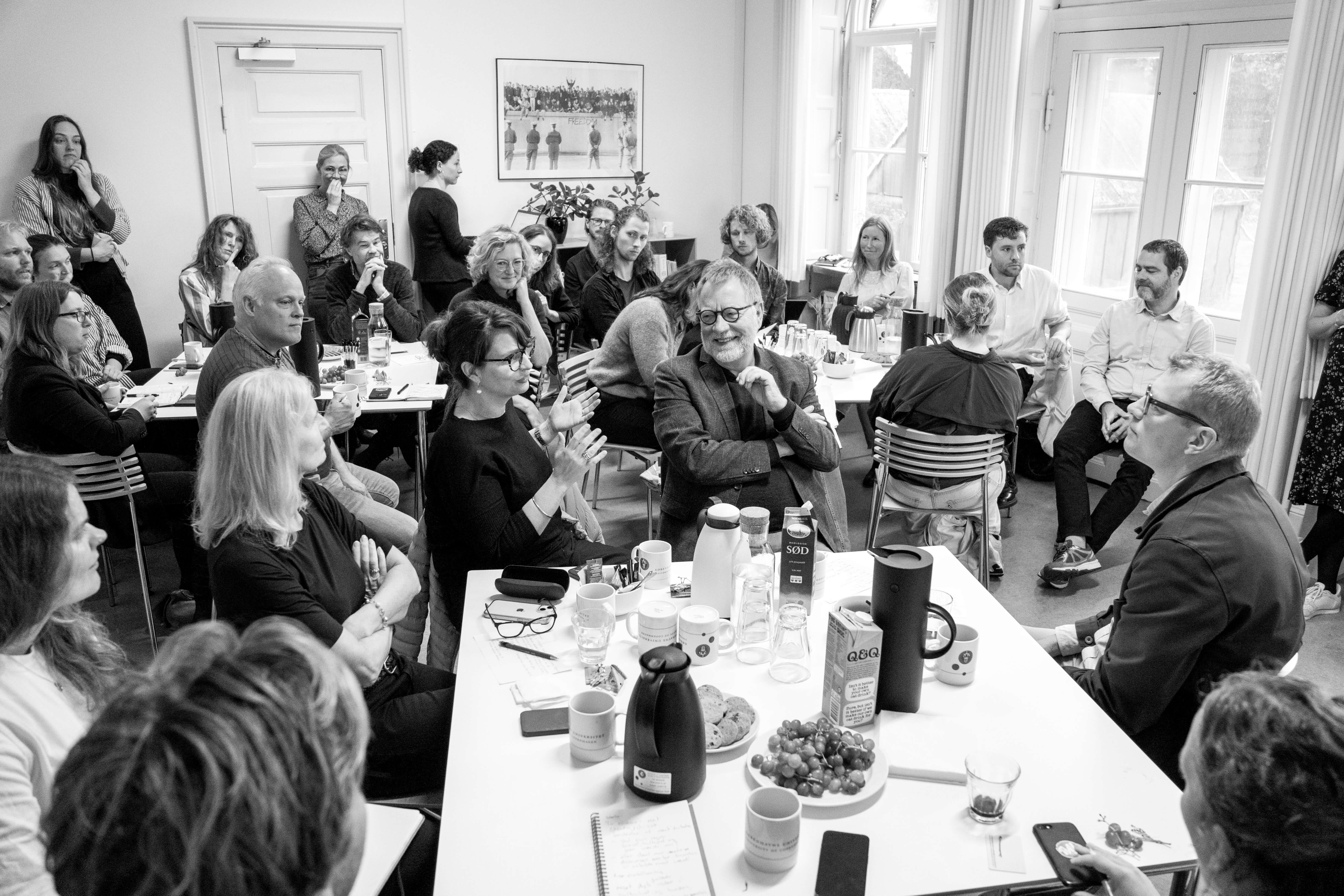 A room filled with people listening attentively to a speaker